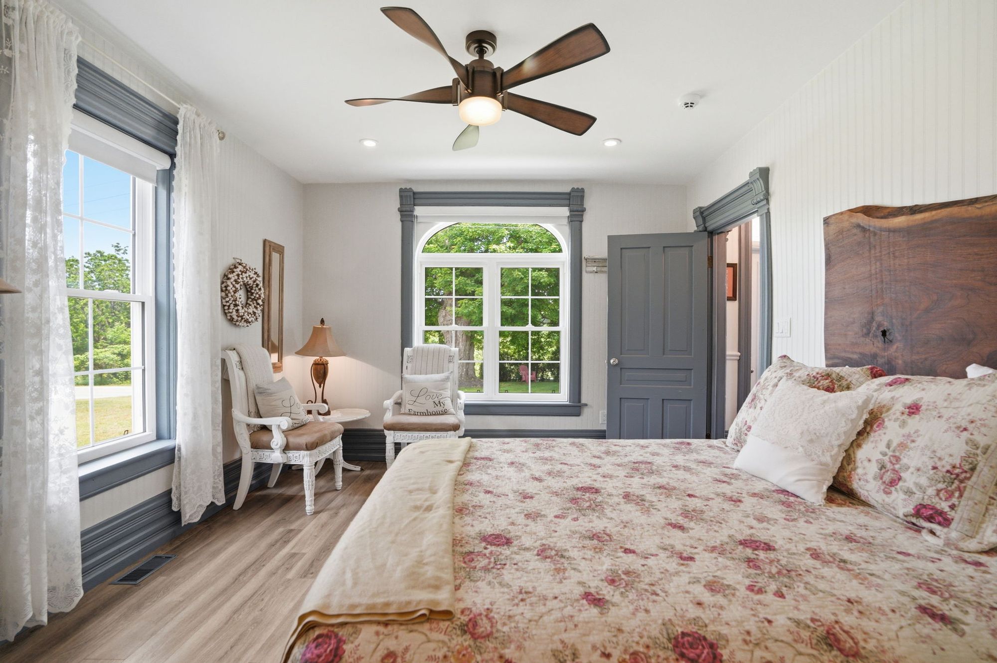 A guest bedroom with a live-edge headboard