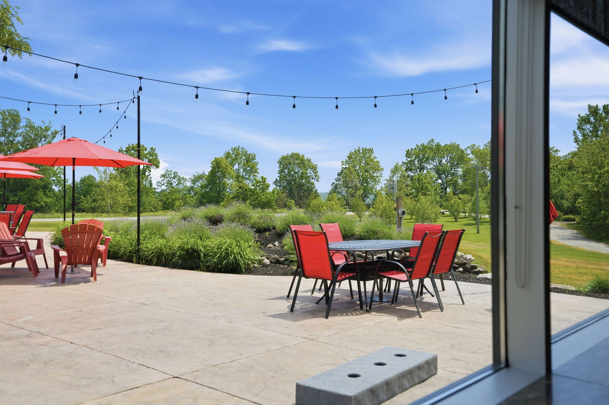 From inside, the patio and the lawn through the glass