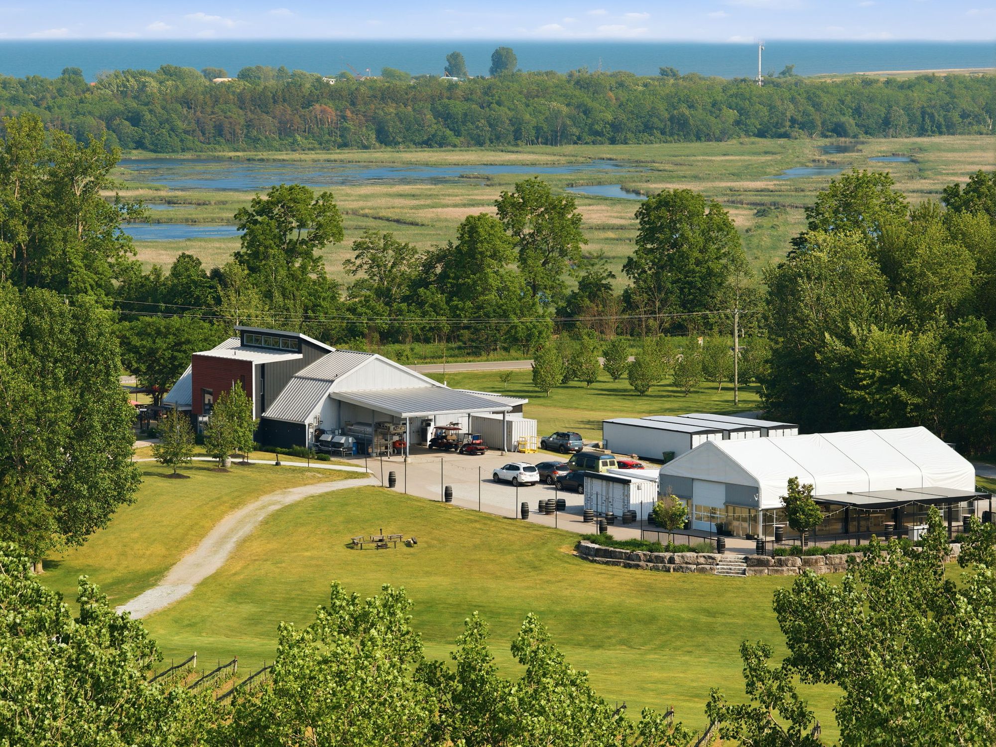 The winery and the event space with the marsh beyond, from the hill above the vines