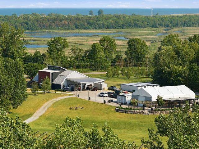 The winery and the event space with the marsh beyond, from the hill above the vines